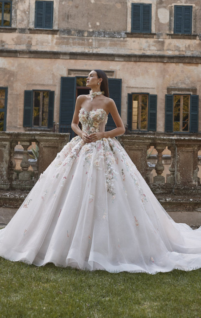 Woman in a wedding dress standing in front of an old building